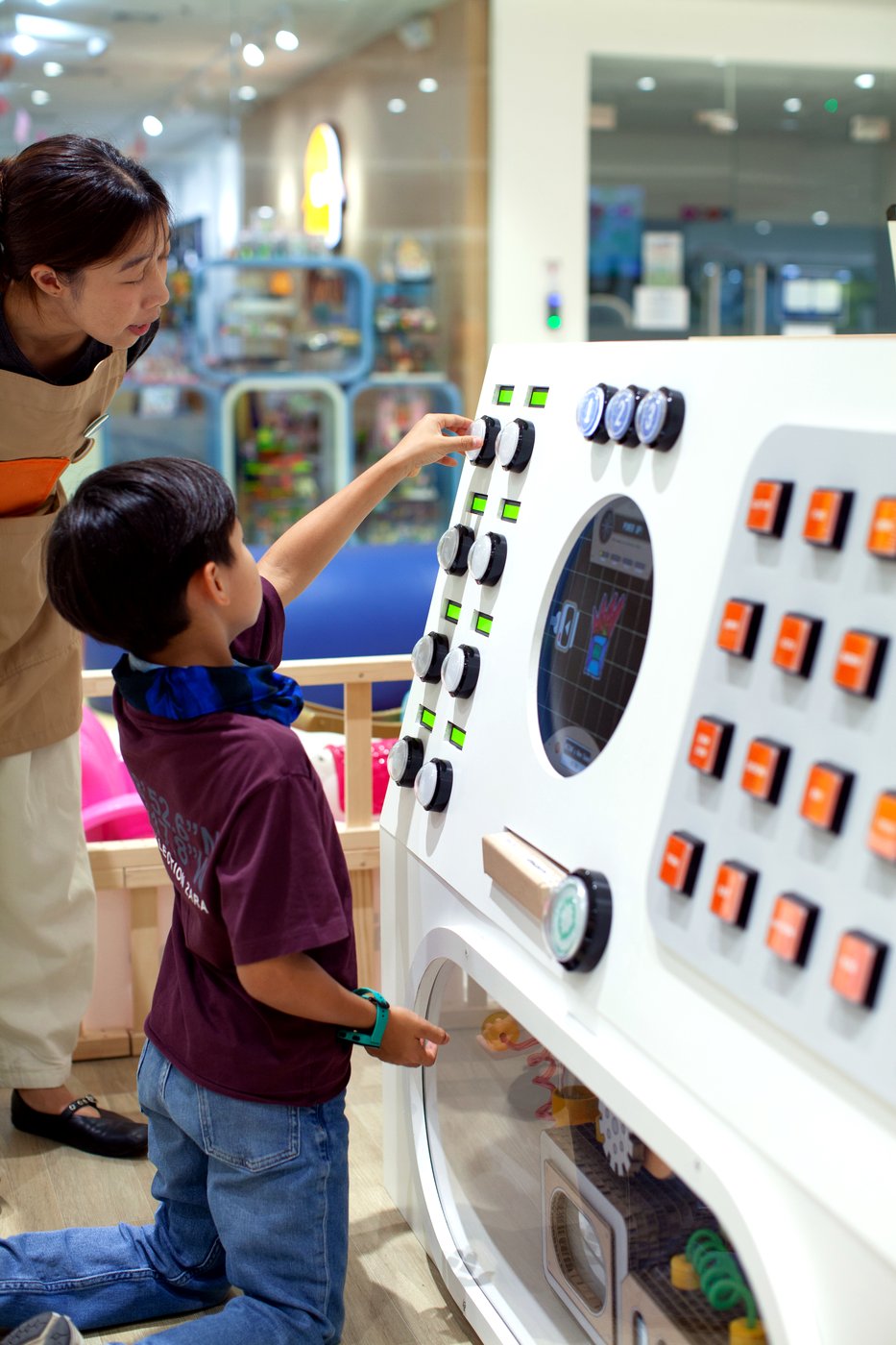 A child playing on the colourful Gametory Arcade game wall