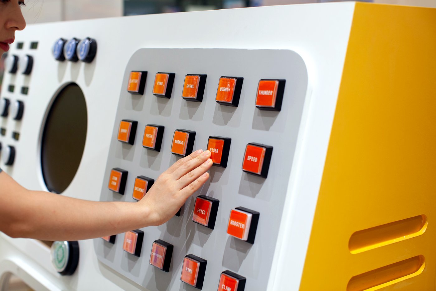 A child pressing the illuminated buttons on the Gametory play panel
